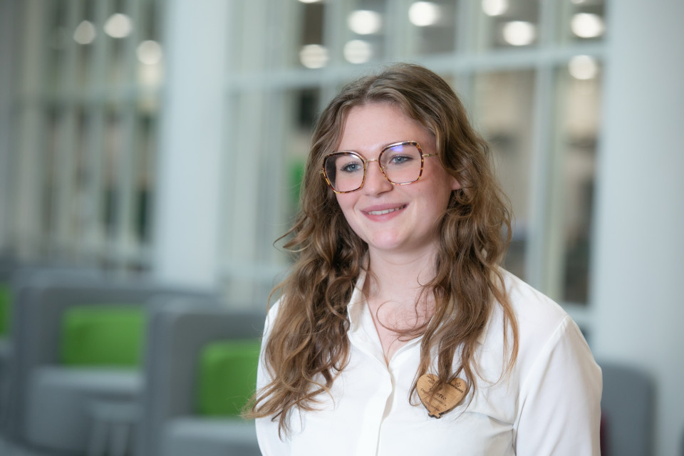 Colleague with glasses smiling in office