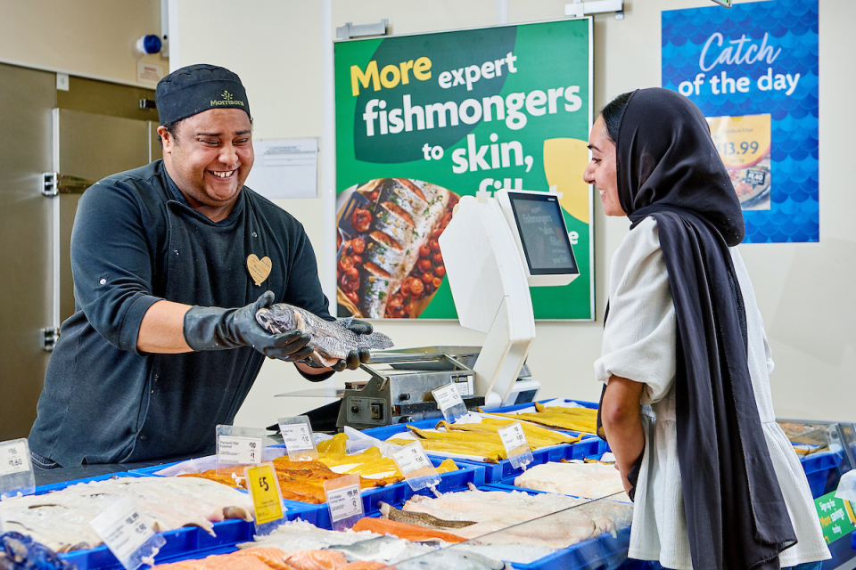 Fishmonger colleague serving a customer in store