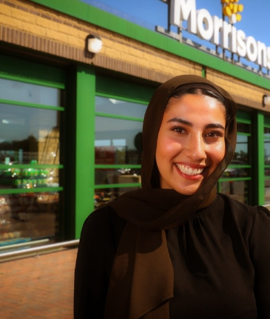 Colleague smiling outside Morrisons store