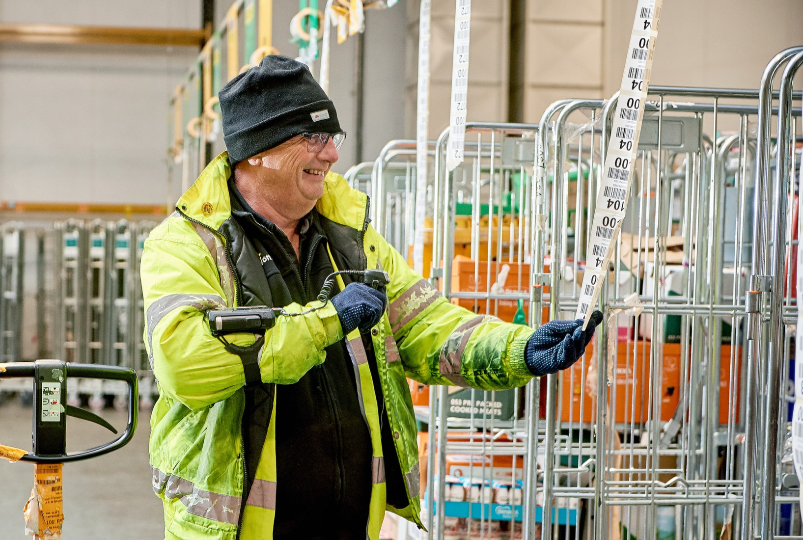 Warehouse colleague scanning from a roll of labels