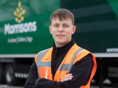 Male colleague in high vis jacket in front of lorry